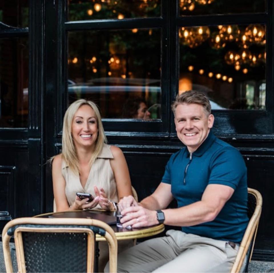 Danny and Katie Bloomfield smiling together. A couple known for building a life and business rooted in authenticity, alignment, and reinvention.