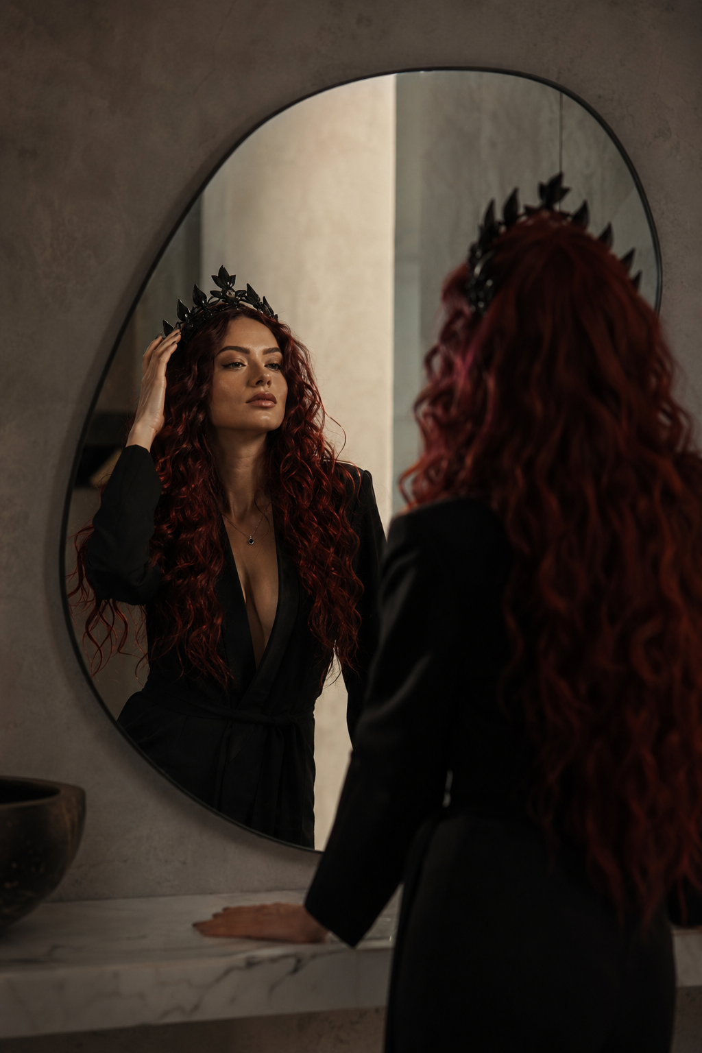 Confident woman adjusting a subtle crown in a luxury setting, representing identity reinvention and becoming your future self