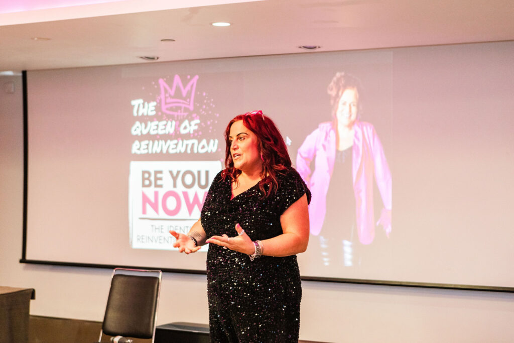 Sarah Elizabeth speaking at Be You Now about identity reinvention and closing the gap between your current and future self.